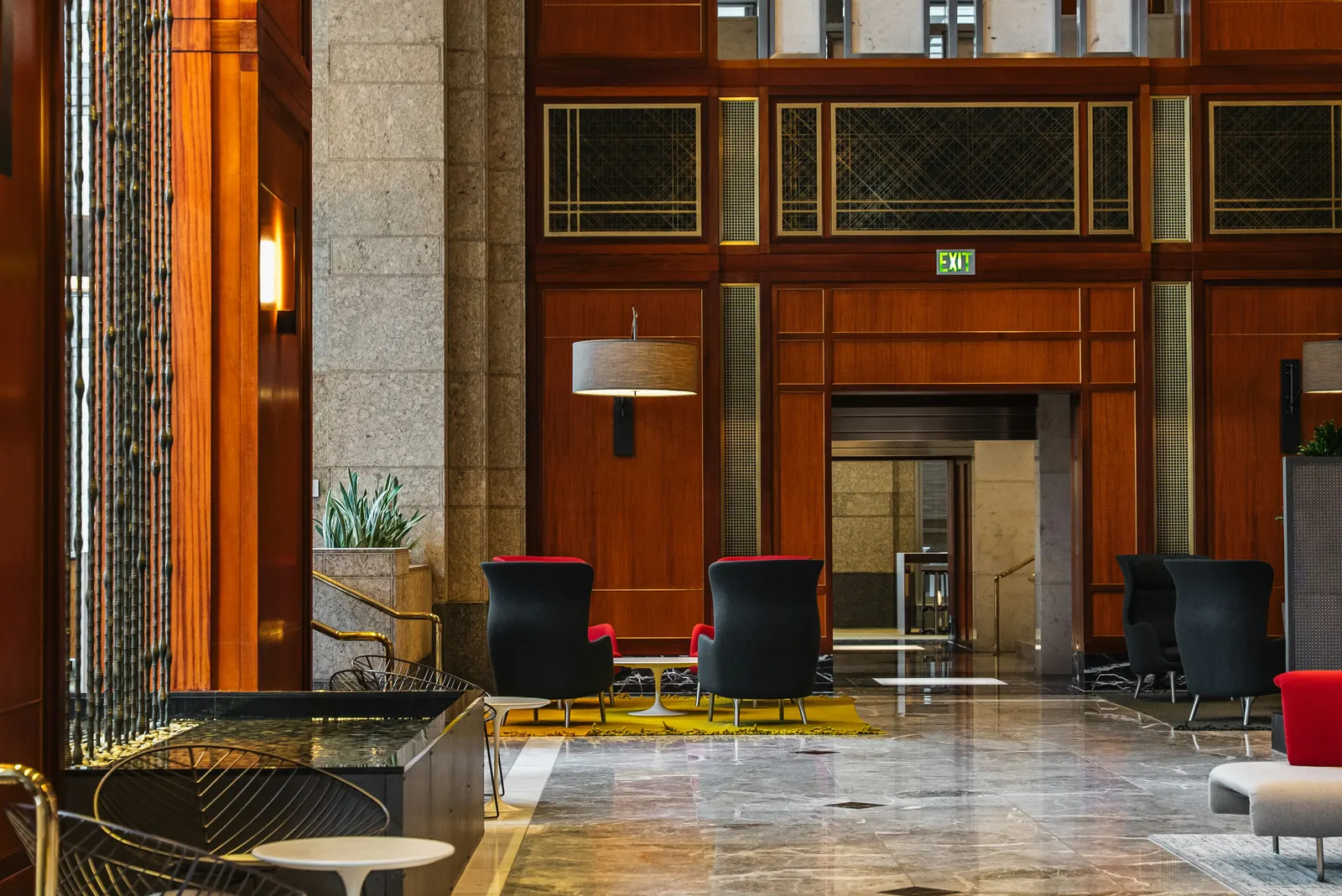 A wood-panelled hotel lobby with lounge seating